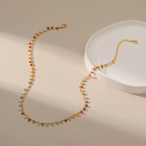 Ethnic style 18K gold plated copper necklace with colorful seed beads on beige background