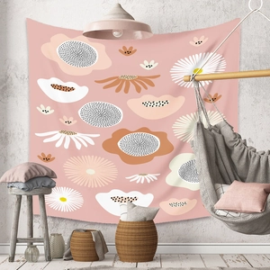 Detailed interior view of soft pink floral tapestry hanging on a bohemian style wall