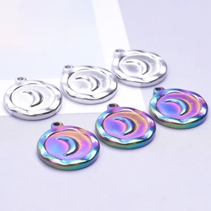 Macro shot of stainless steel sun and moon charms in silver and rainbow finishes