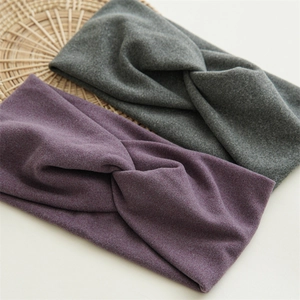 Detail of plush knotted headbands in grey and purple soft fabric for women