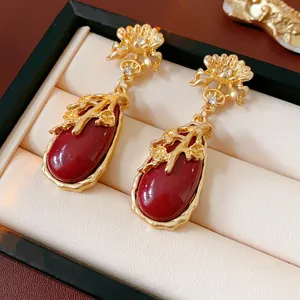 Vintage style drop earrings with red teardrop gemstones and gold floral engraving