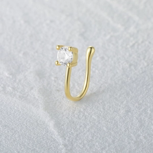Close-up of golden S925 sterling silver U-shaped nose cuff with sparkling cubic zirconia