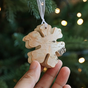 Creative wooden snowflake Christmas tree ornament with rustic bark texture and ribbon