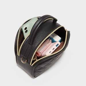 Black quilted crossbody bag with triple gold zippers and diamond lattice stitching