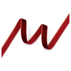 Detail of burgundy velvet ribbon with gold edges in a wavy layout for Christmas DIY decor