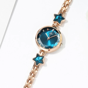 Fashionable gold watch for women featuring a blue star design and faceted glass dial