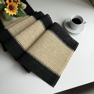 Detailed view of striped paper rope woven table runner with modern textured finish