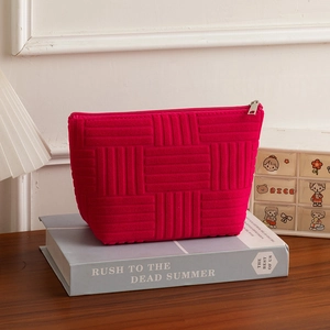 Detailed texture of rose pink ribbed towel fabric cosmetic bag with metal zipper