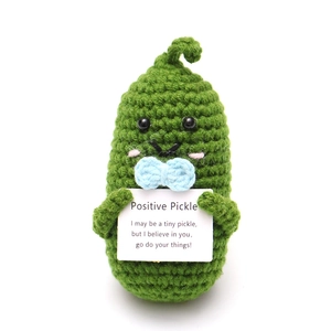 Handmade crochet positive pickle doll with a blue bow and inspirational card