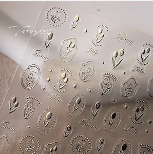 Close-up of 3D embossed gold tulip nail art stickers with Spring and Tulip motifs