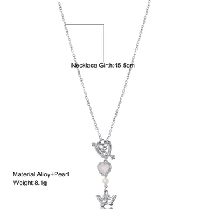 Detail view of alloy heart pendant with Cupid's arrow and pearl accents on white backdrop