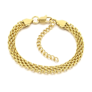 Flat lay of a woven golden titanium steel bracelet with lobster clasp and extender