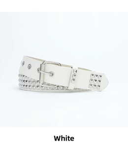 Close-up of white punk belt with three rows of silver pyramid studs and a metal buckle