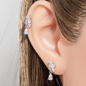 Silver butterfly ear studs with pink zircon drop pendant shown on model's ear