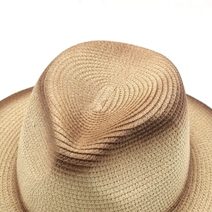 Close-up of the gradient brown woven straw hat showing fine spiral textures and mesh