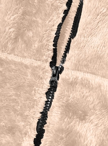 Close-up of black zipper detail on soft beige fleece jacket with high-density texture