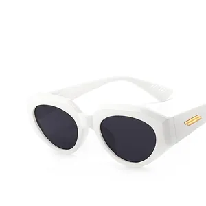 Irregular retro cat eye sunglasses with white geometric frames and gold temple accents