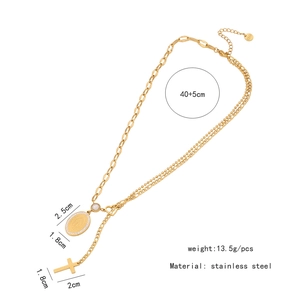 Detail of double-layer stainless steel gold necklace with cross and Mary pendants