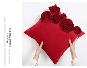 Detail of red velvet pillow cover featuring 3D handmade roses and invisible zipper