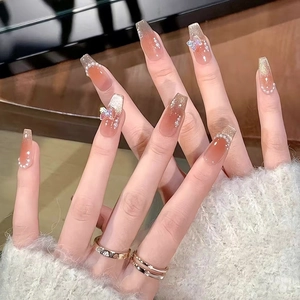 Blush gradient press-on nails with 3D butterfly charms and aurora cat eye finish.