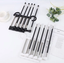 Detail of 5-tier S-shaped stainless steel pants hangers in black and white colors