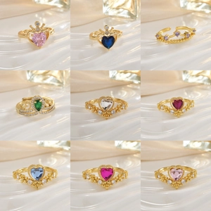Golden crown rings set with colorful heart-shaped gemstones and micro-inlaid details