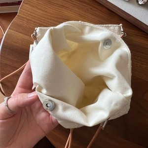 Detail view of cotton linen crossbody bag interior with secure metal magnetic closure