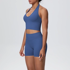 Detail of dark blue ribbed halter neck sports bra and high-waisted seamless biker shorts