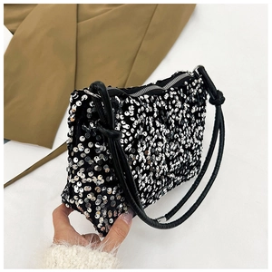 Detail of sequin shoulder bag showing sparkling texture and silver metal zipper closure
