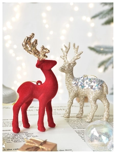 Detail of red flocked and gold sequin reindeer ornaments for a warm Christmas tree decor