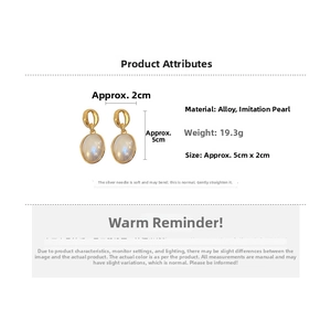 Detail view of oval faux pearl drop earrings in vintage gold finish with 5cm dimensions