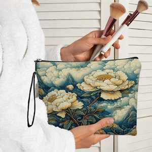 Floral canvas makeup bag with peony illustration and zipper, held in a home setting