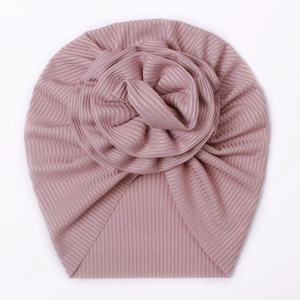 Close-up of pink ice silk ribbed baby turban featuring a large 3D floral knot detail