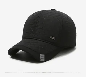 Detail view of black quilted baseball cap with diamond texture and sport fashion label