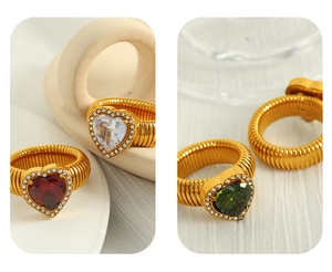 Detail of ribbed gold heart rings with colorful gems and sparkling crystal accents