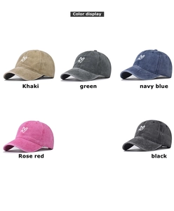Detailed view of washed cotton baseball caps in multiple colors with heart embroidery