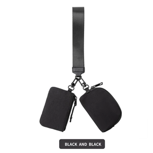 Detail of black waterproof nylon wrist bag featuring dual pouches and a wide woven strap