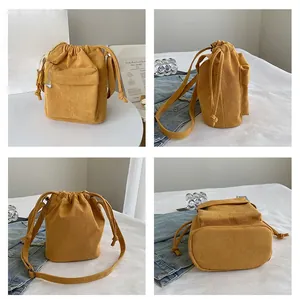 Detailed four-view of yellow corduroy drawstring bucket bag with front zipper pocket