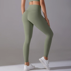 Close-up of high-waist yoga leggings with side pockets and peach lift seam in sage green