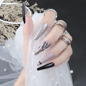 Long ballet press-on nails in light purple with glitter and black floral leaf patterns