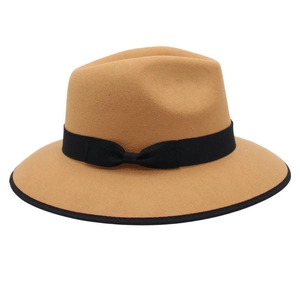 Detail of camel wool fedora hat featuring black ribbon band and elegant bound edge trim