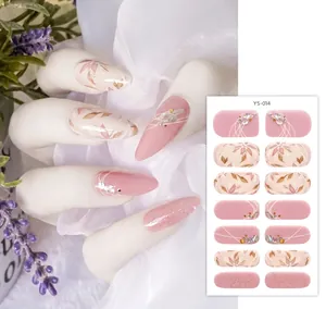 Macro detail of YS-014 floral nail wraps with rhinestones on stiletto nails