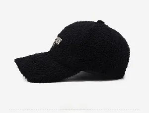 Detail of side embroidery and fuzzy teddy fleece texture on black baseball cap