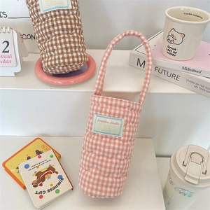 Close-up of quilted checkered water bottle carrier bag with soft padded handle detail