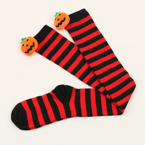 Close-up of Halloween over-knee socks with red-black stripes and plush pumpkin charm