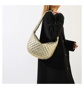 Metallic gold quilted dumpling bag with crescent shape and chic diamond stitching detail