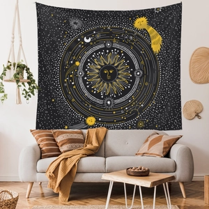 Detail of bohemian sun and moon tapestry hanging above a sofa in a cozy living room