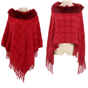Detail of red checkered knit poncho featuring a fur collar and elegant fringe hem