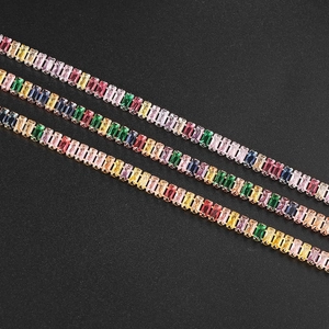 Close-up of rainbow rectangular zircon tennis bracelets with gold plated settings