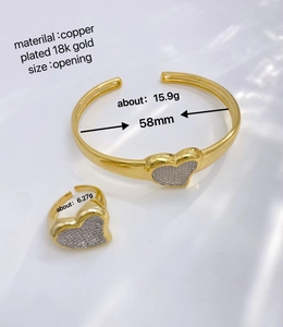 Detailed macro view of 18k gold plated copper heart jewelry set with cubic zirconia stones